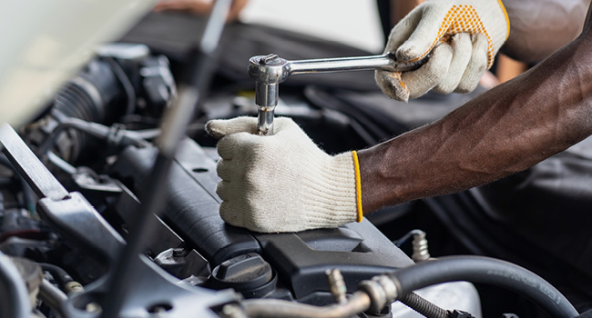 Mechanic hands working on engine